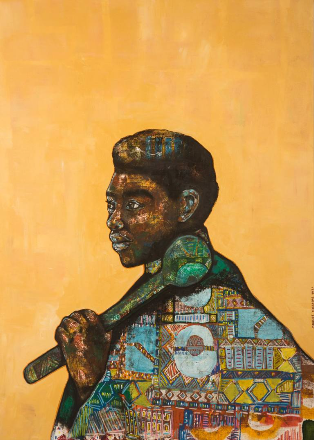 From the chest up, a man with dark brown skin stands in front of a yellow background looking to the left. He is draped in fabric with a variety of traditional South African designs. In his hand, resting over his left shoulder he holds a teal, decorated object which consists of a long handle and a bulb at the upper end.